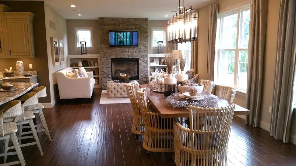 Bright great room with linear fireplace and open dining designed by Matthew Alexander Creations