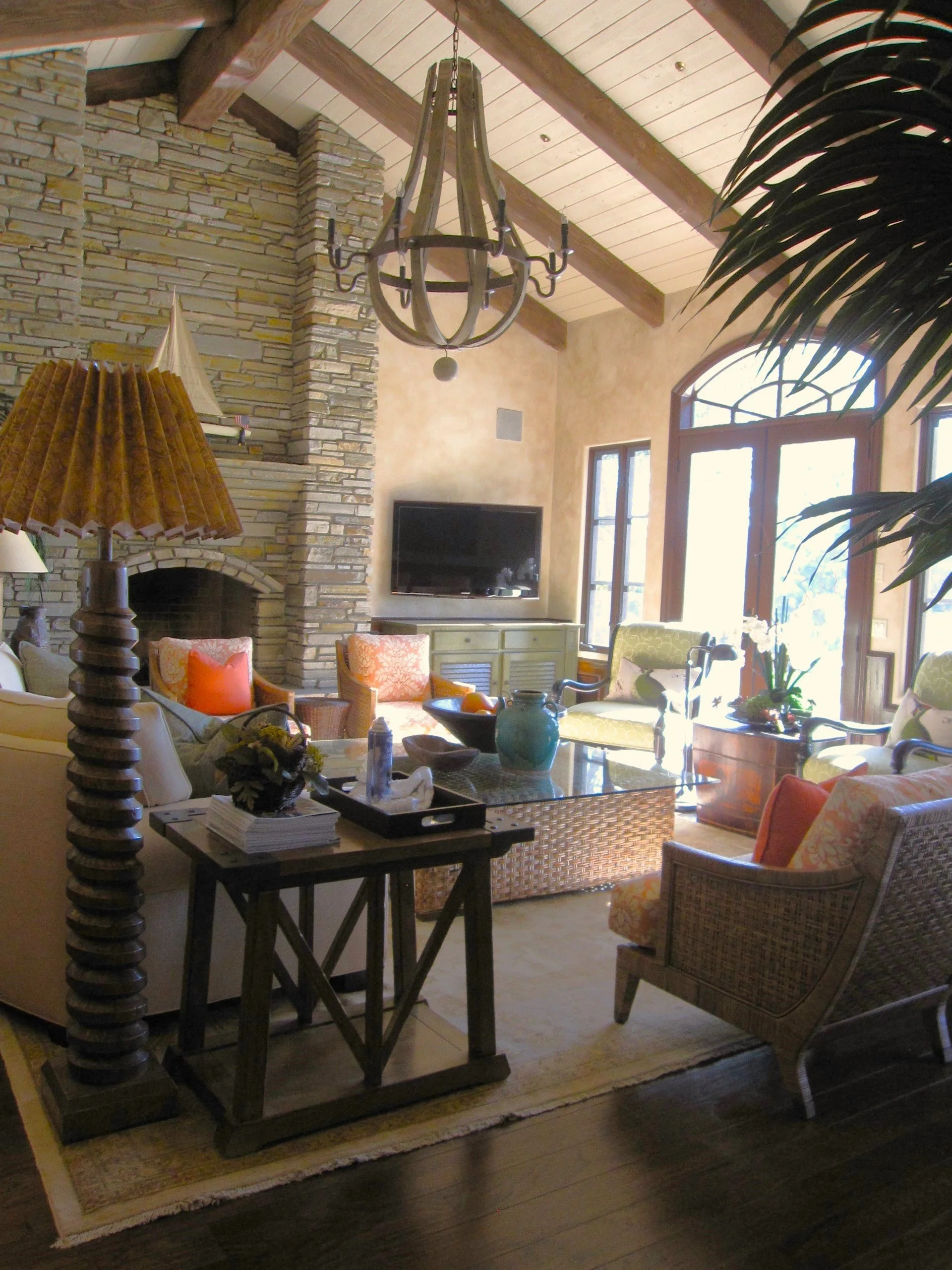 Vaulted great room with beamed ceiling and stone fireplace