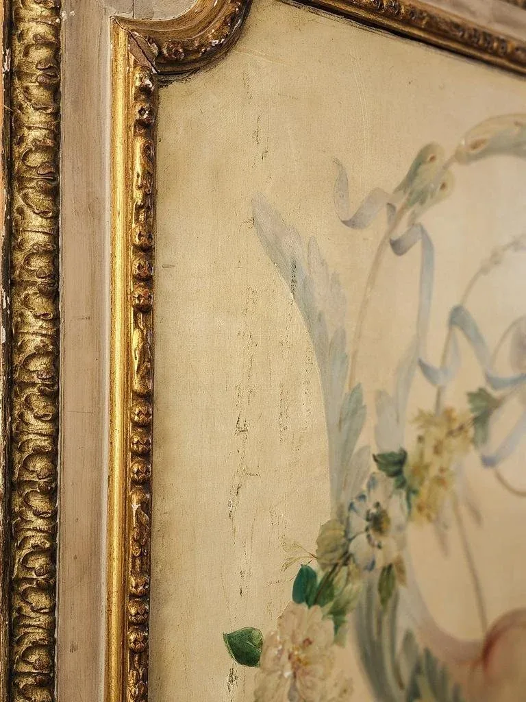 Detail of a gilt-framed botanical artwork with hand-painted foliage.