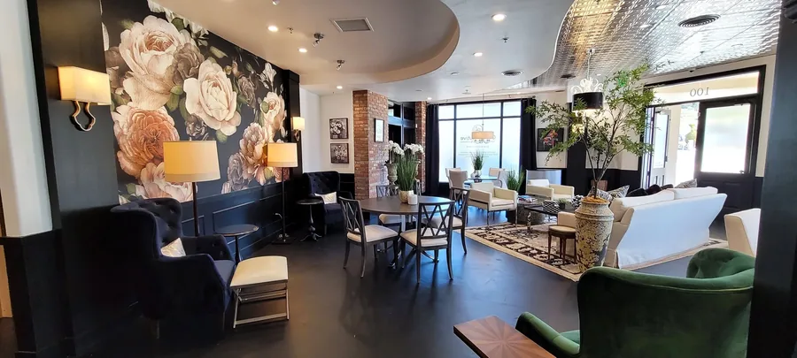 Open living and dining space with a large floral mural wall and contemporary furniture.