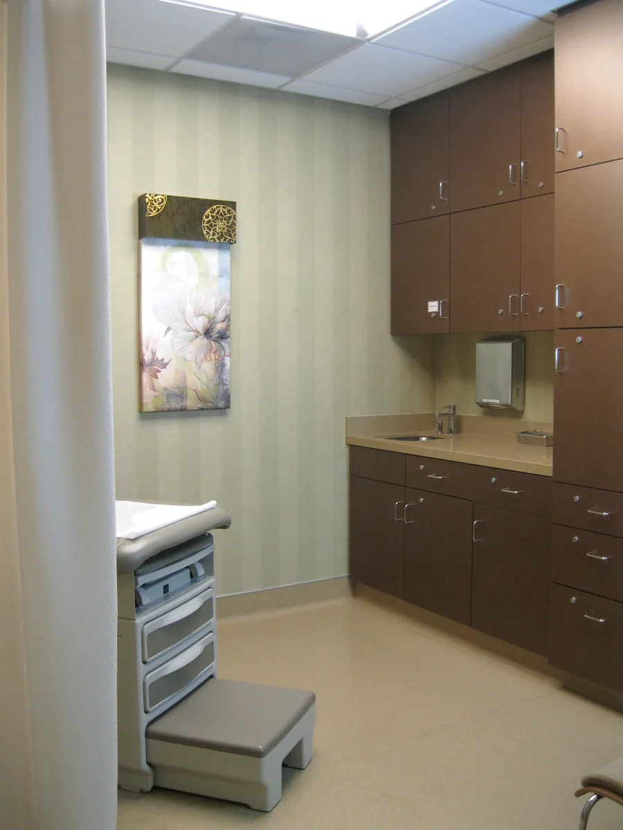 Medical office treatment room with clean custom cabinetry and calm neutral finishes.
