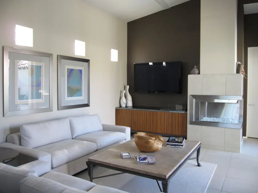 Contemporary living room with a floating media wall, gas fireplace and a grey sofa.