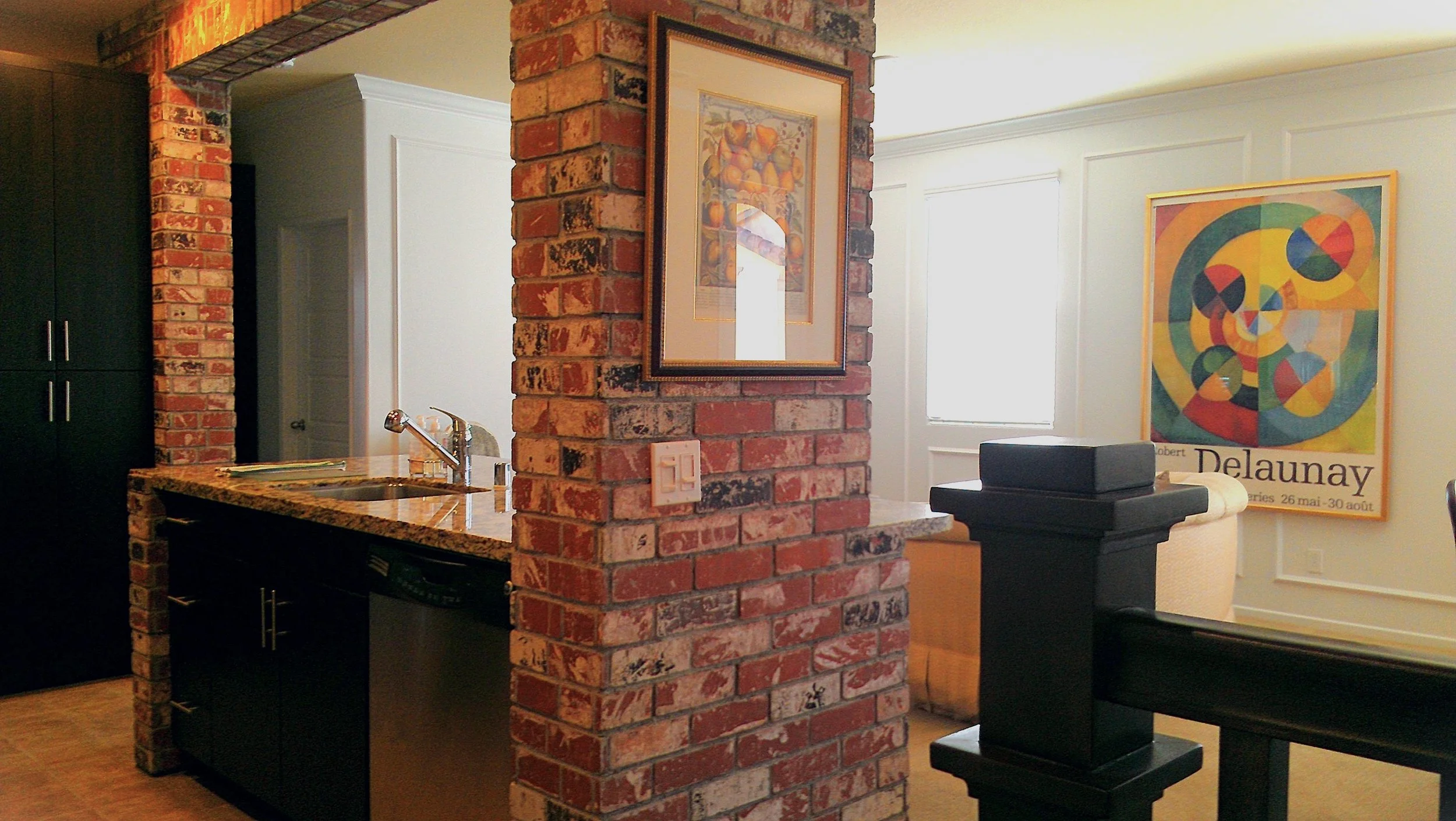 Custom butler's pantry with exposed brick and cabinetry, delivered through full project management